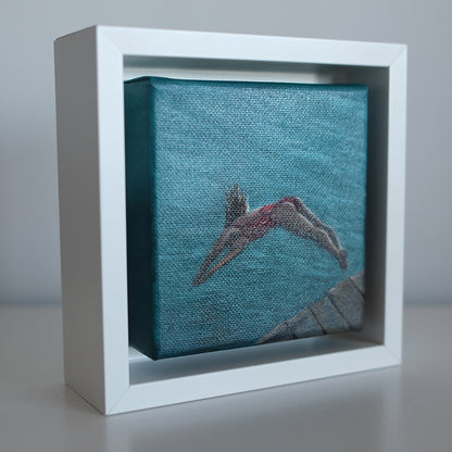 Side view of framed 4x4 swimmer oil painting — coastal wall art featuring diver and ocean tones.