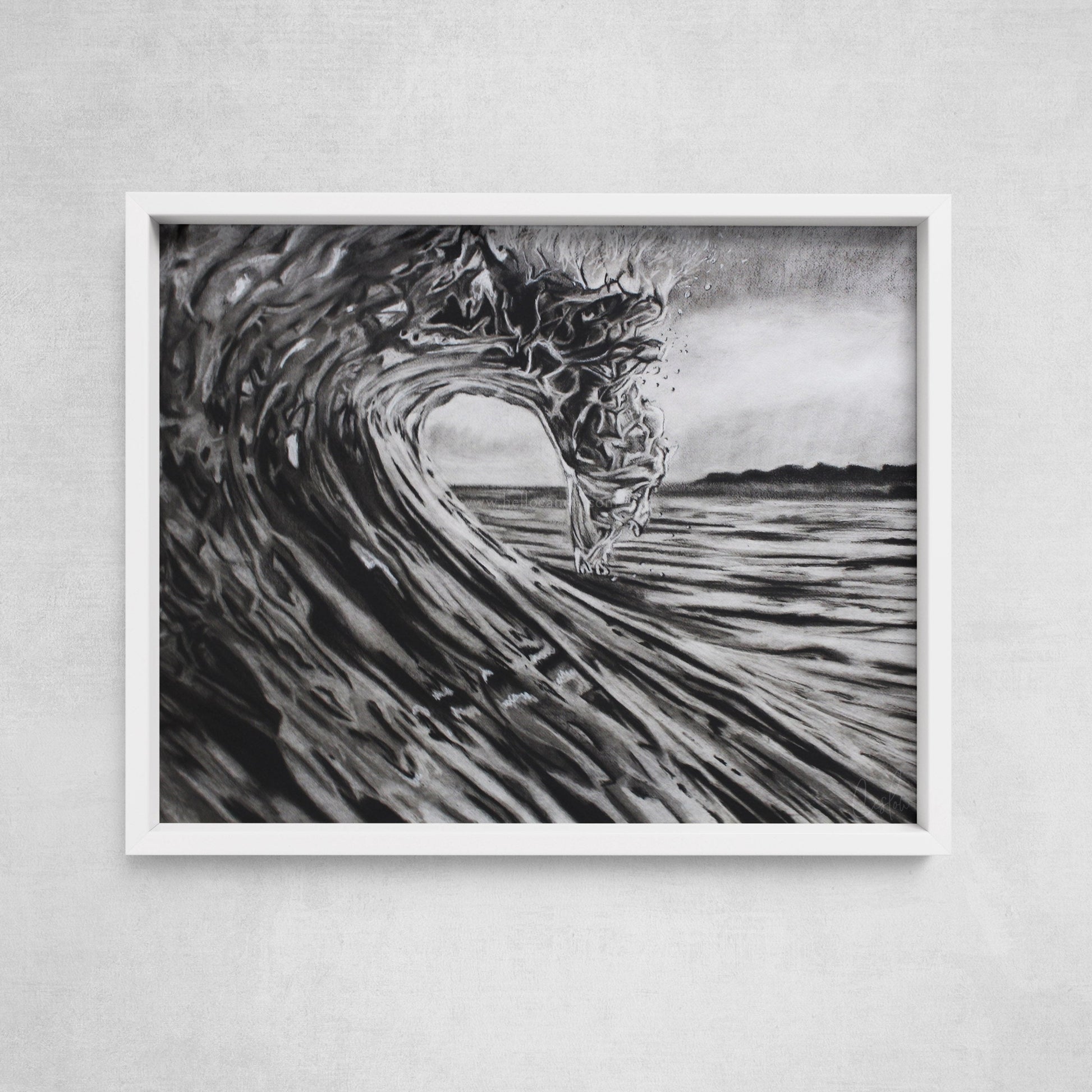 A framed black and white charcoal drawing of a breaking wave, displayed on a wall.