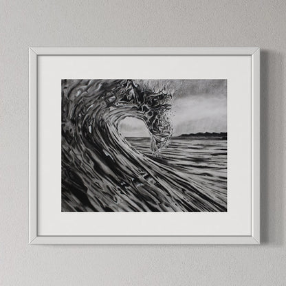 Framed black and white artwork of a wave on a gray wall