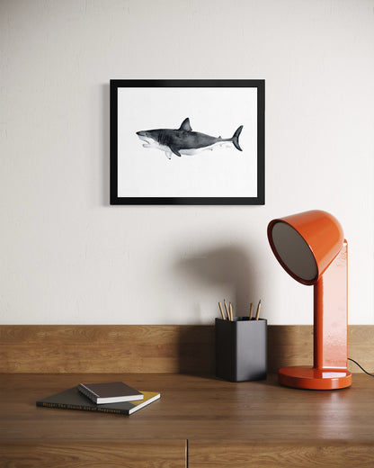 Watercolor-style great white shark print in black frame above wood desk by Candace Ceslow