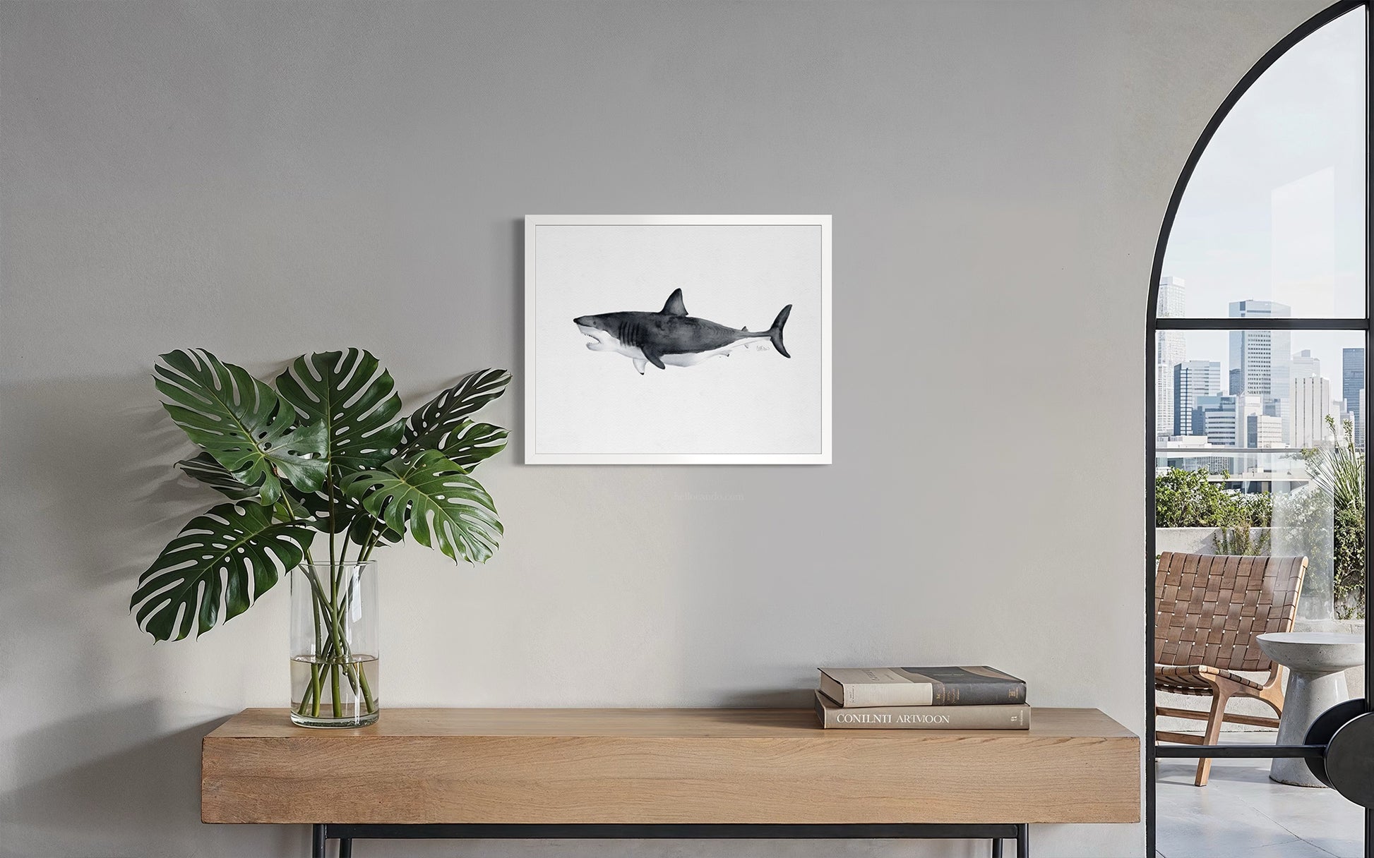 Great white shark watercolor-style print in white frame above console table in modern entryway by Candace Ceslow