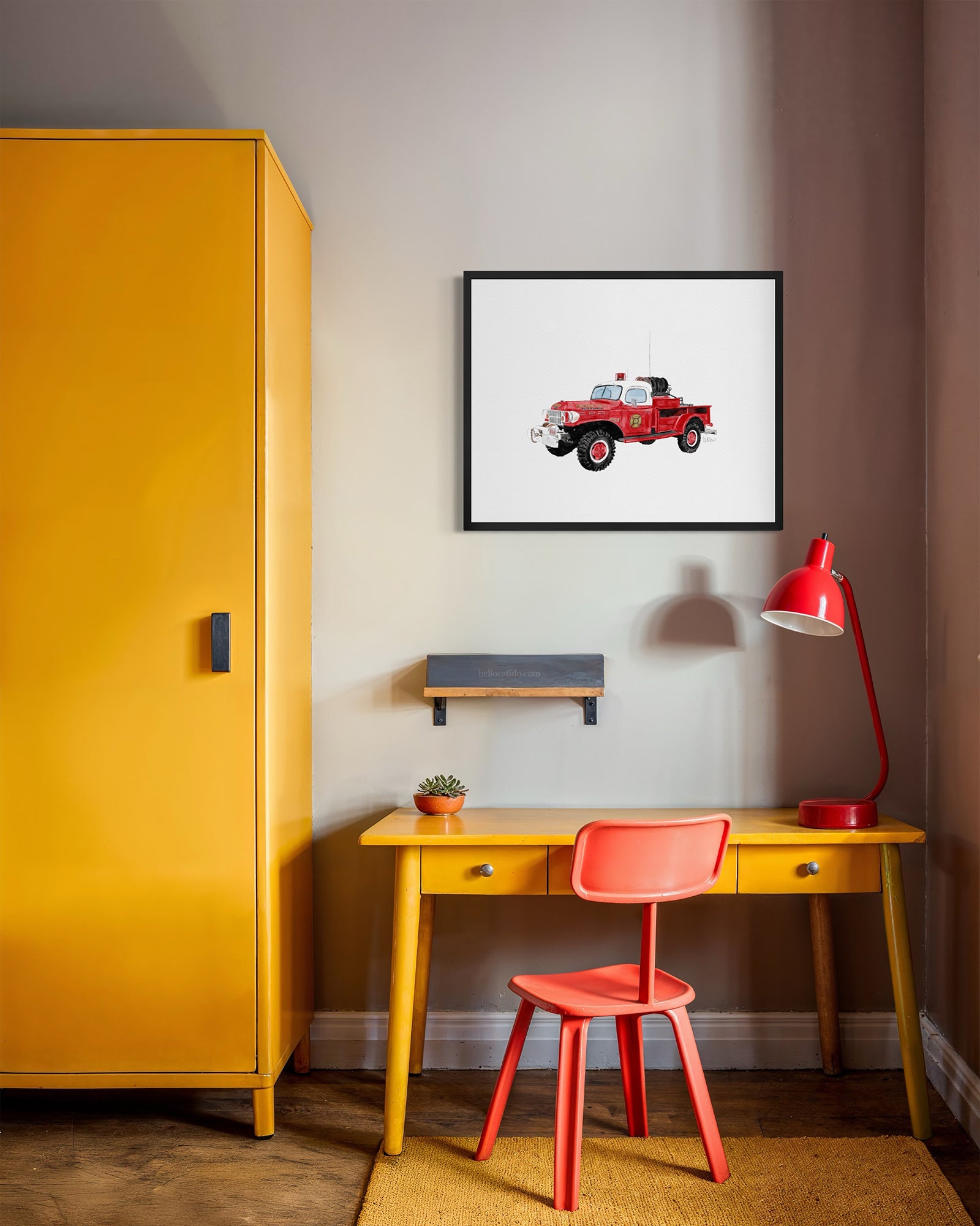 Vintage Montauk fire truck watercolor-style print in black frame above yellow kids desk by Candace Ceslow
