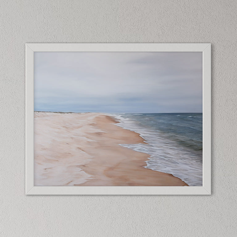 Framed artwork of a beach scene on a gray wall