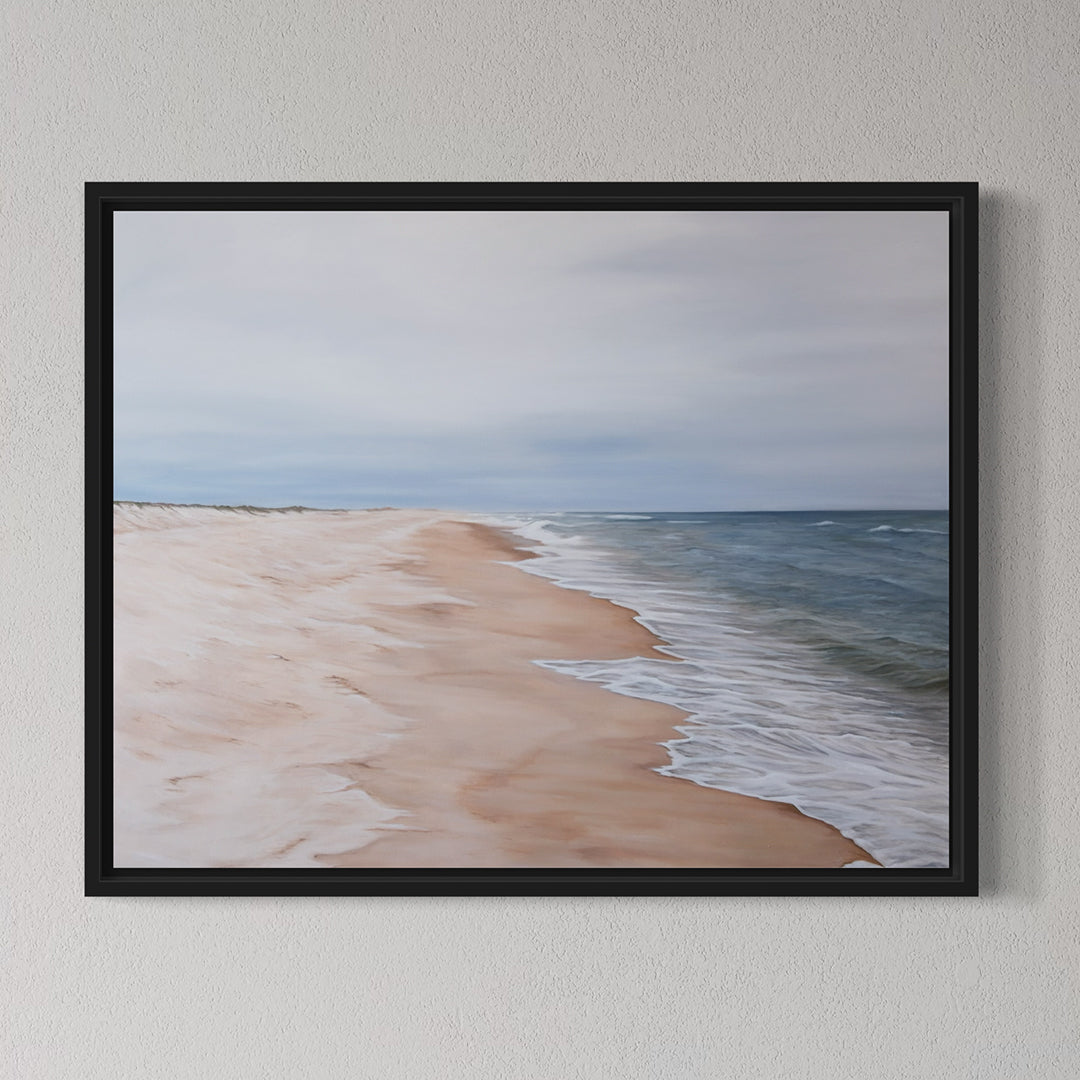 Framed artwork of a beach scene with ocean and sky.