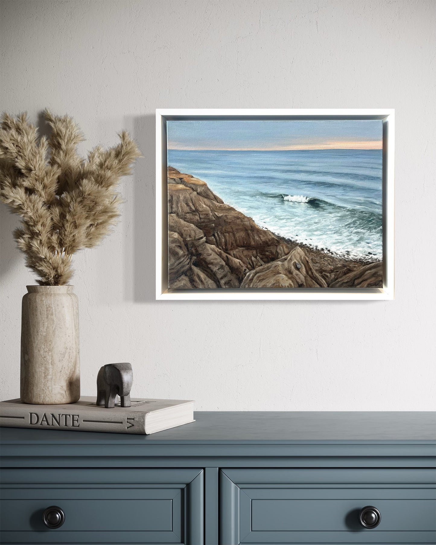 Framed original Montauk coastal oil painting We're Not Alone by Candace Ceslow displayed above dresser in coastal home interior