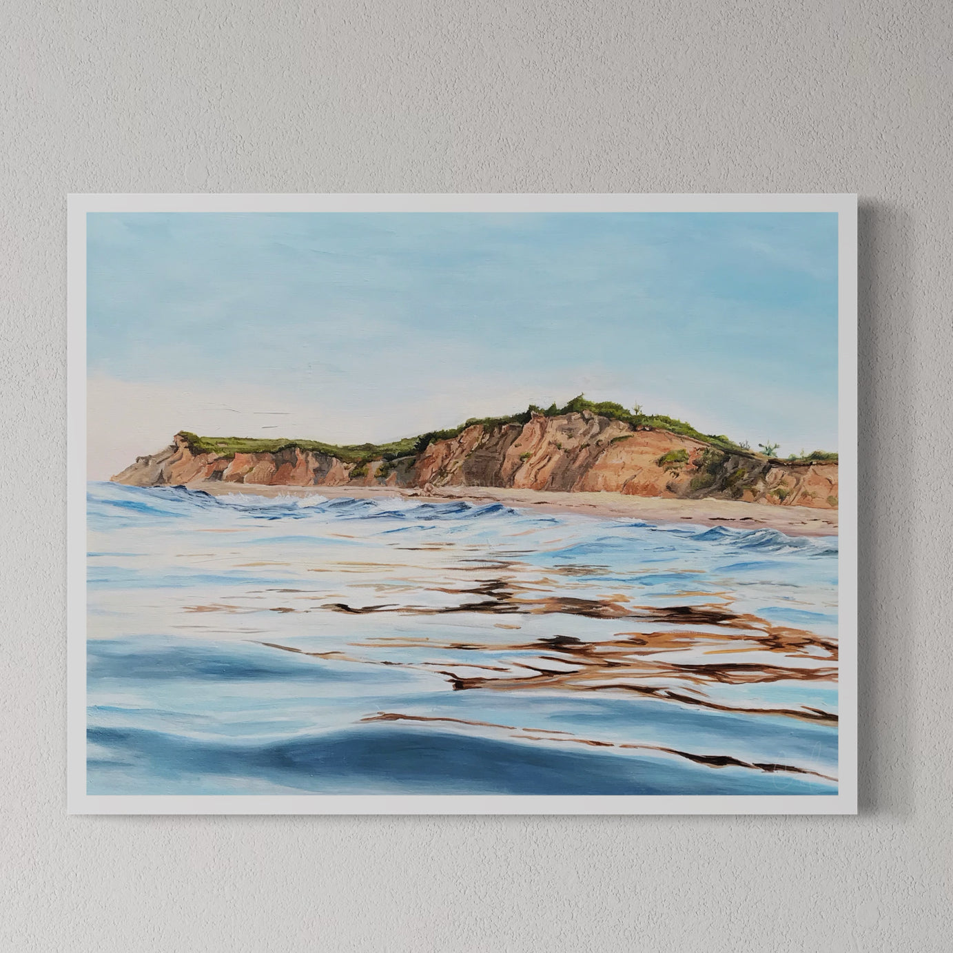 A framed fine art print of a coastal landscape, depicting Montauk Hoodoos and Shadmoor viewed from the water, with a clear blue sky and calm ocean waters.